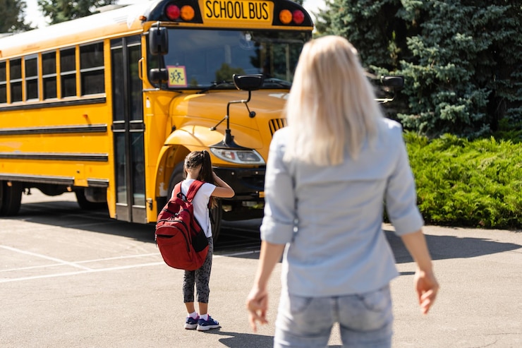 mother brings her daughter school near school bus back to school